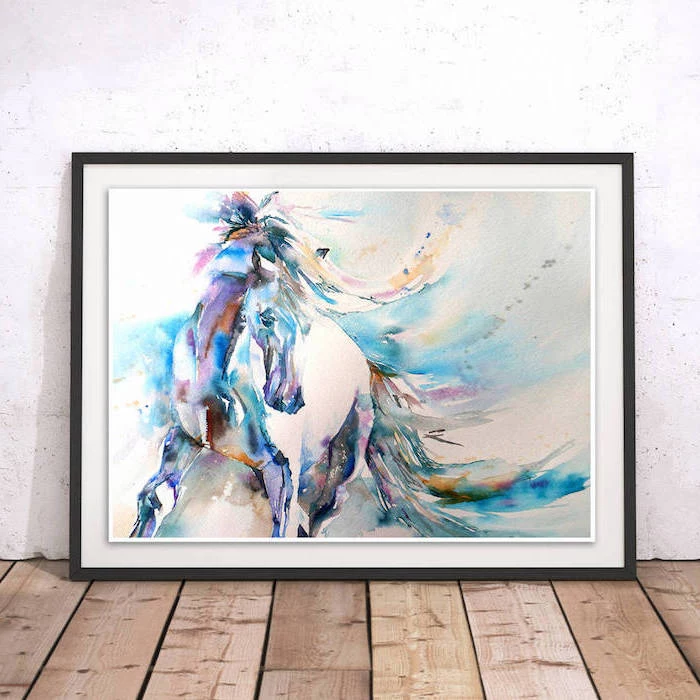 drawing of a horse, painted in different colors, inside black frame, easy watercolor ideas, white wall