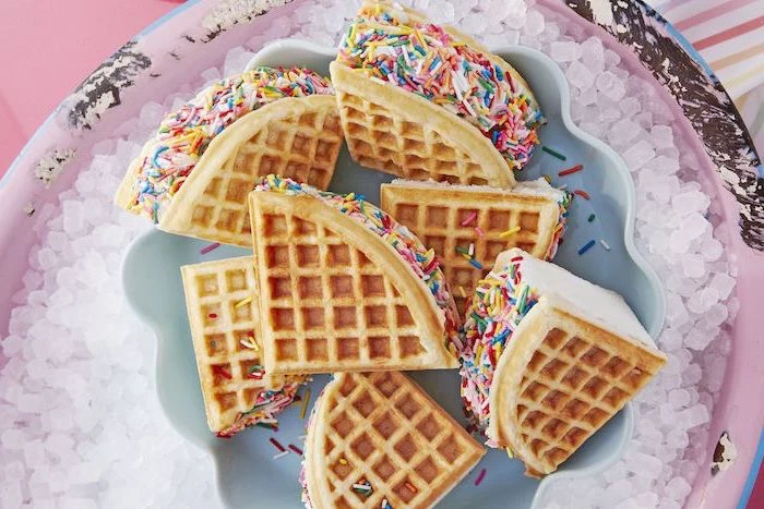 ice cream sandwiches made with waffles and sprinkles on top easy summer desserts arranged on plate placed on ice