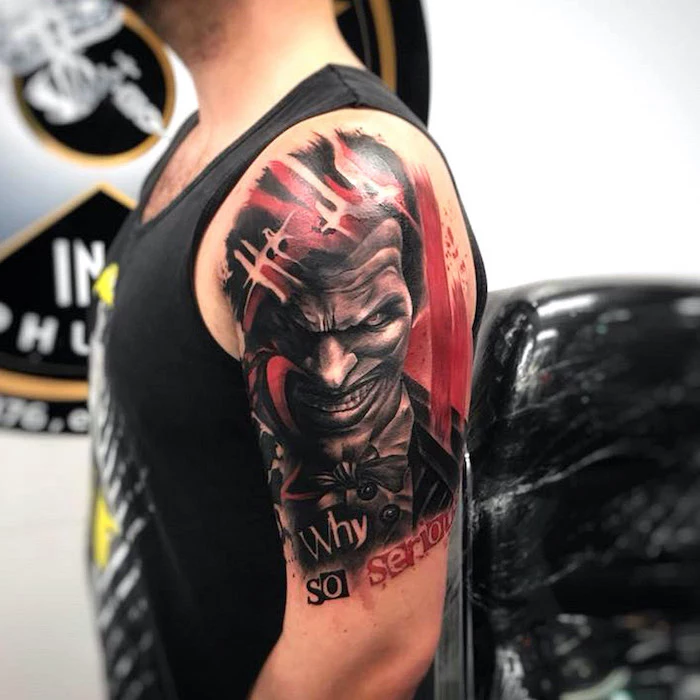 joker tattoo why so serious written underneath trash polka eagle tattoo shoulder tattoo on man with black top