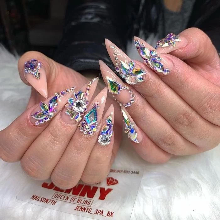 long stiletto nails, bright nail colors, nude nail polish, decorations with different rhinestones