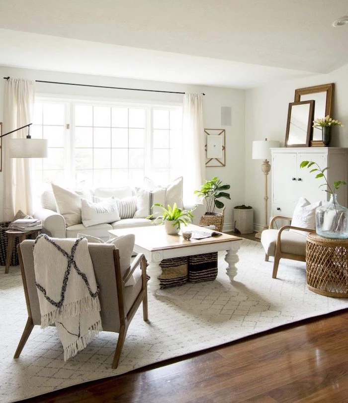 white sofa, two grey armchairs, country decorating ideas, wooden coffee table, white carpet on wooden floor
