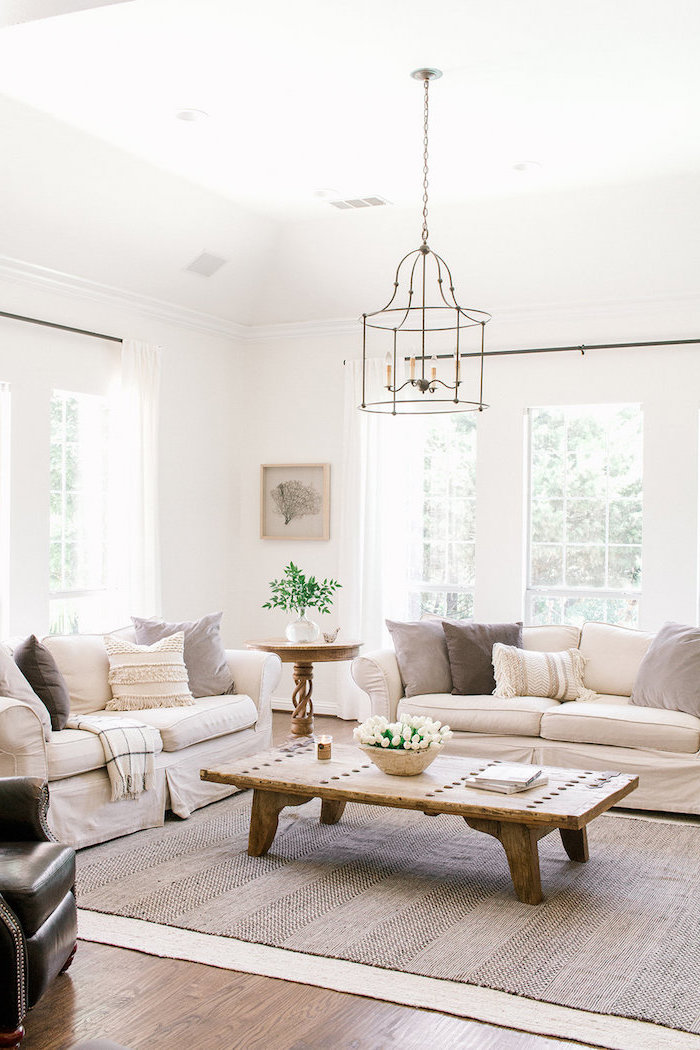 two white sofas, white and grey throw pillows, wooden coffee table, country decorating ideas