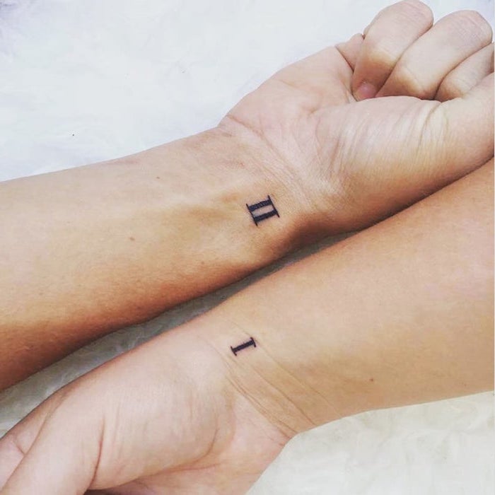 one and two roman numerals matching sibling tattoos matching wrist tattoos white background
