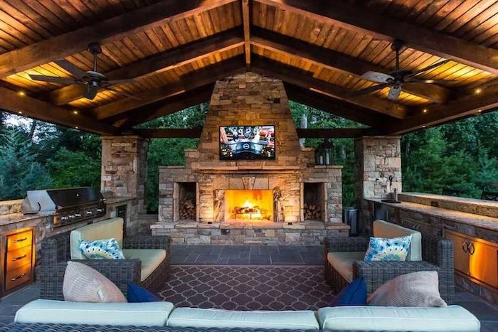 outdoor grill ideas vaulted wooden ceiling with fans stone fireplace lounge are with sofas and armchairs grill with cabinets