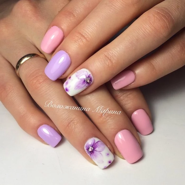 pink and purple nail polish, blue nail designs, purple flowers decoration, medium length squoval nails