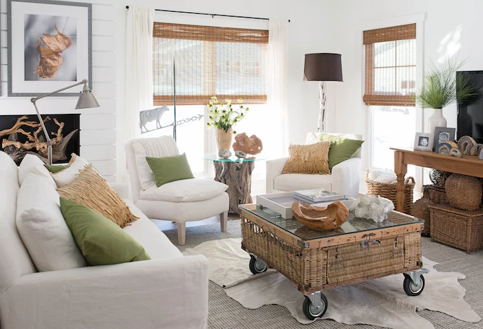 ratan coffee table on wheels, white furniture set, green throw pillows, modern farmhouse interior, white walls