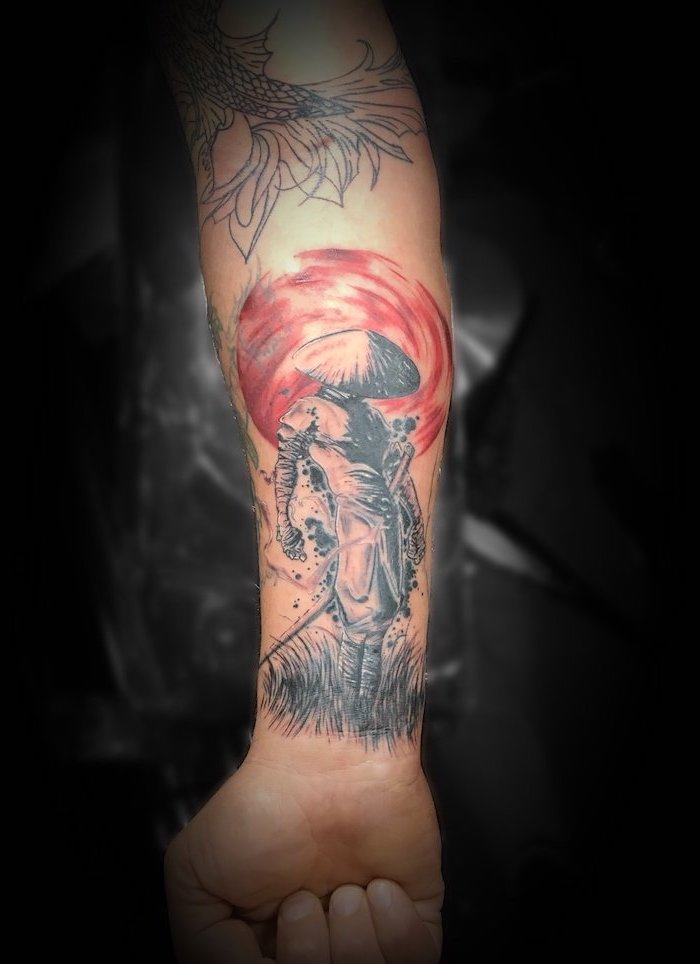samurai standing in the grass red sun behind him polka tattoo style forearm tattoo