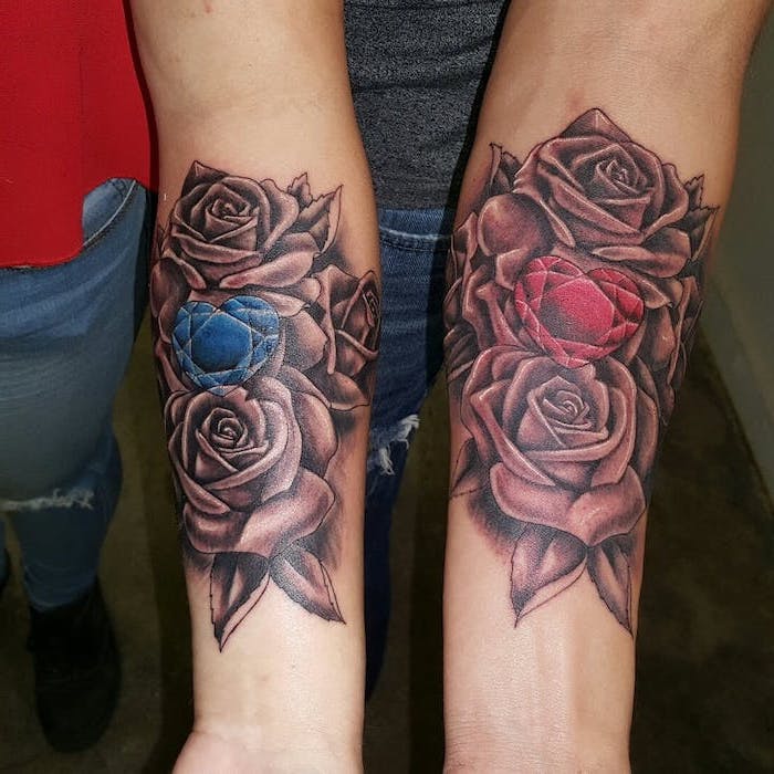 sibling tattoos for 4 forearm tattoos of a bunch of roses with red and blue heart crystals