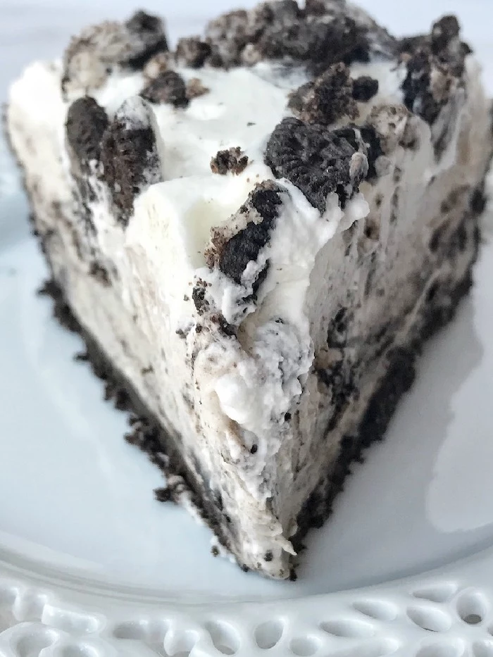 slice of oreo pudding pie with three layers on white plate best summer desserts made with oreo cookie crumbs