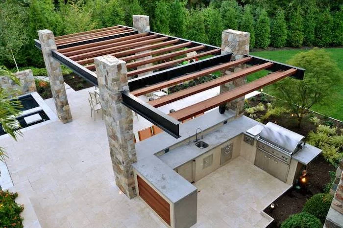 stone tiled floor and columns l shaped outdoor kitchen kitchen area with grill sink metal cabinets