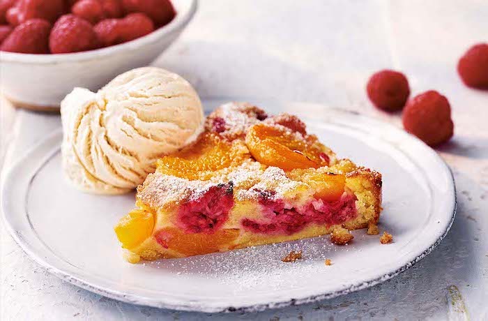 tart with raspberries oranges easy summer desserts placed on white plate ice cream scoop on the side