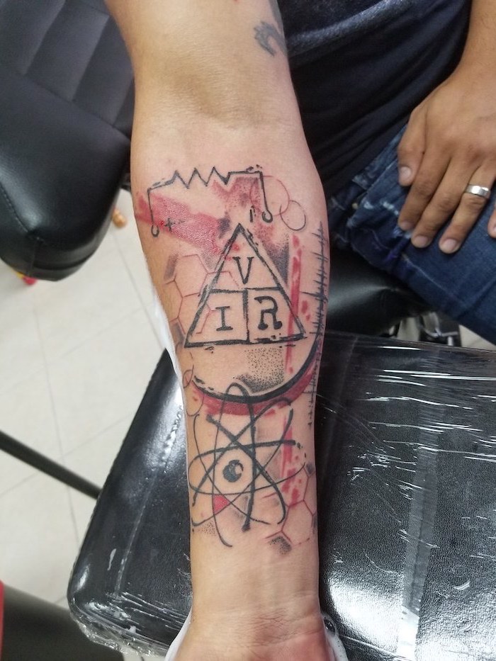 trash polka design triangle with letters inside surrounded by red and black lines forearm tattoo