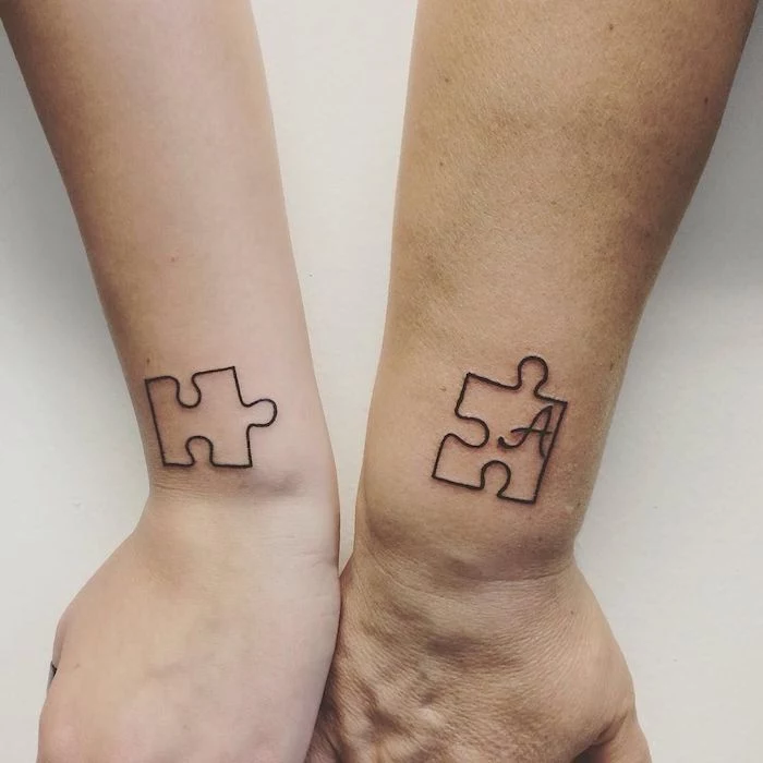 two jig saw puzzles letter a inside one brother sister tattoos small wrist tattoos white background