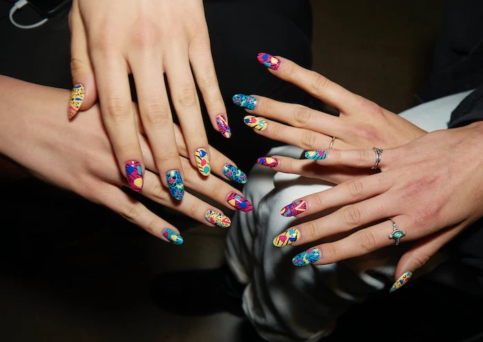 two sets of hands, colorful nail polish, summer nail colors, colorful decorations, long squoval nails