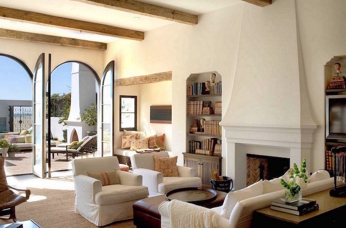 exposed wooden beams on white ceiling, modern farmhouse interior, white furniture set, brown leather ottoman