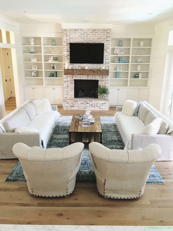 white furniture set, placed in front of a fireplace, farmhouse living room furniture, brick accent column