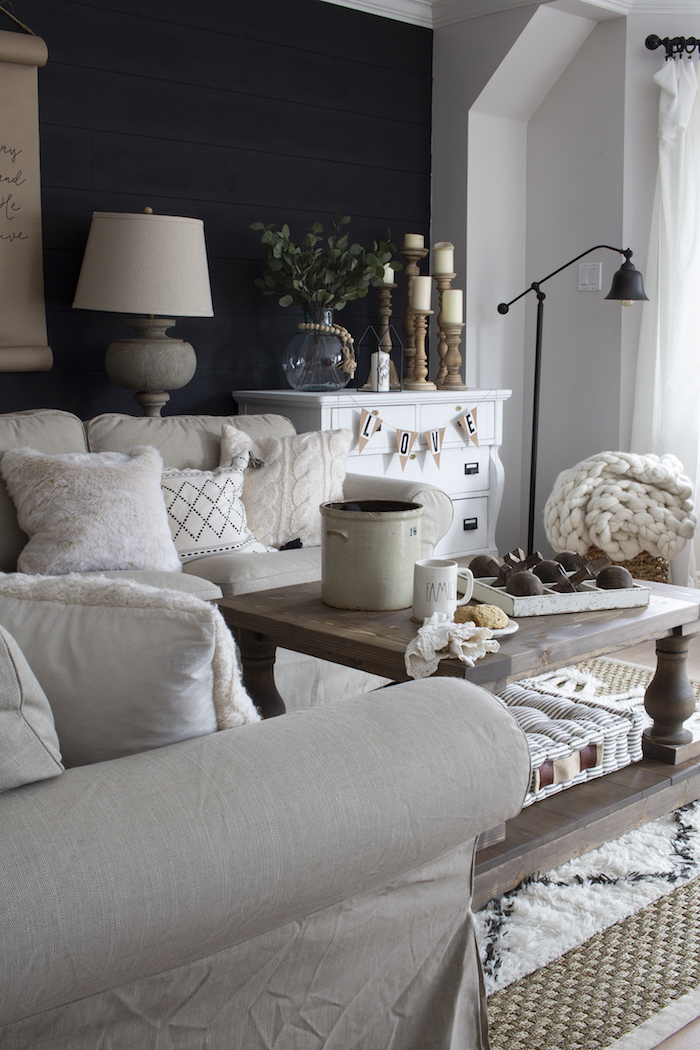 black accent wall, industrial farmhouse decor, white furniture set, wooden coffee table