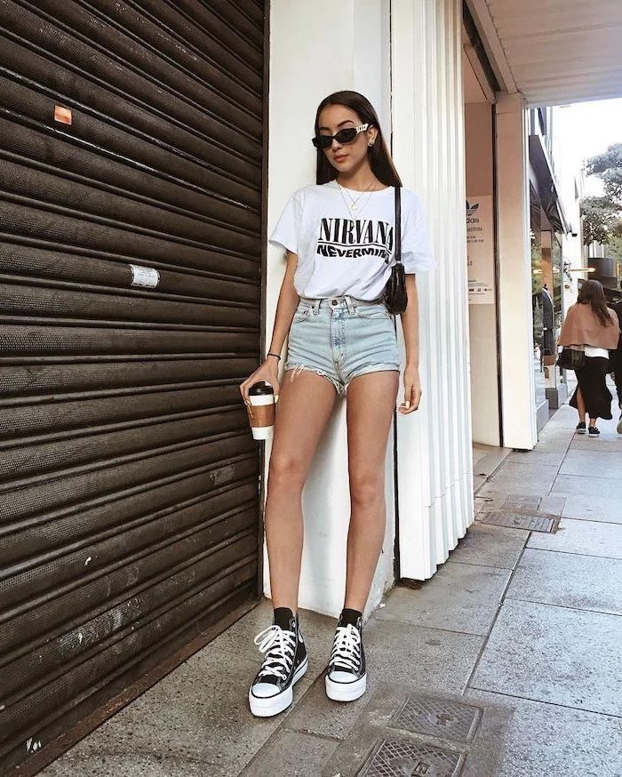 white nirvana t shirt denim shorts worn by girl with long black hair cute summer outfits for teens black and white converse high tops sunglasses