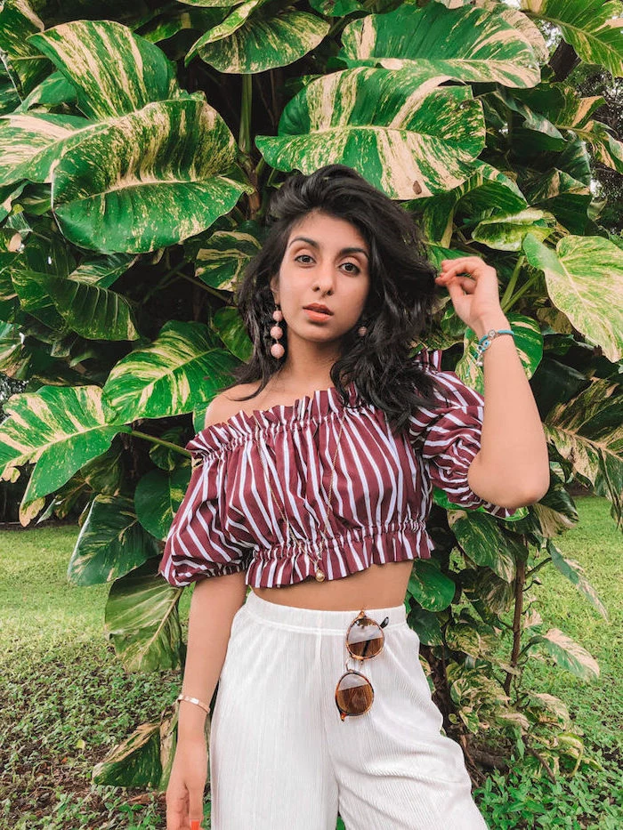 woman wearing pleated high waisted trousers red and white striped crop top cute summer outfits for teens with black wavy hair
