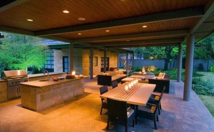 wooden ceiling backyard kitchen kitchen island made of stones outside lounge are with fireplace and sofas
