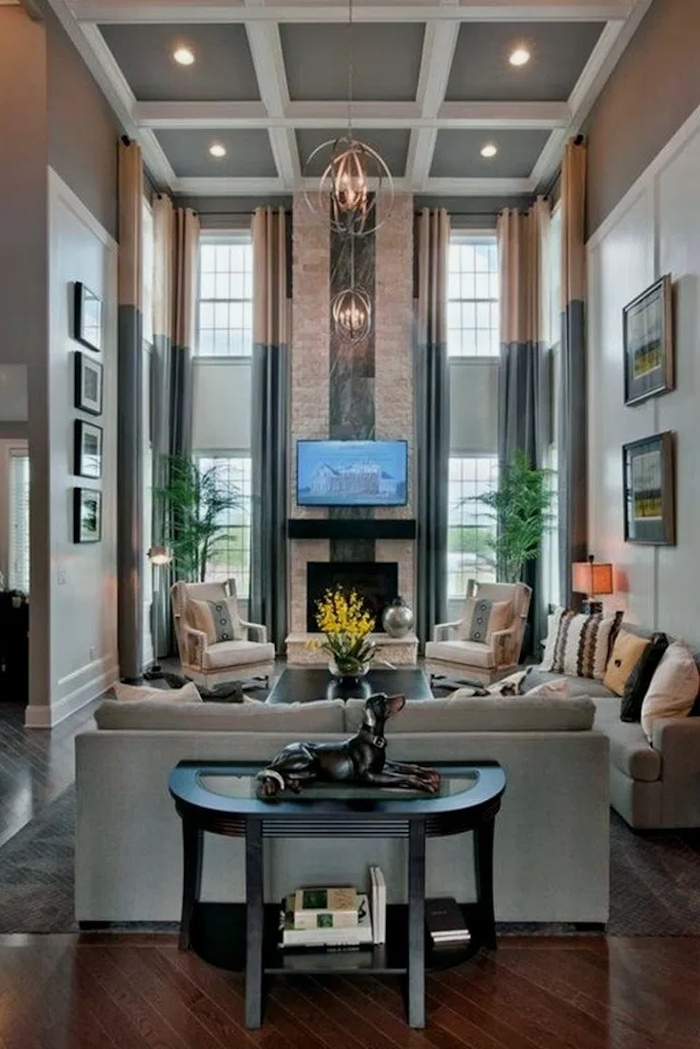 tall walls and windows, country farmhouse decor, grey furniture set, placed in front of a fireplace