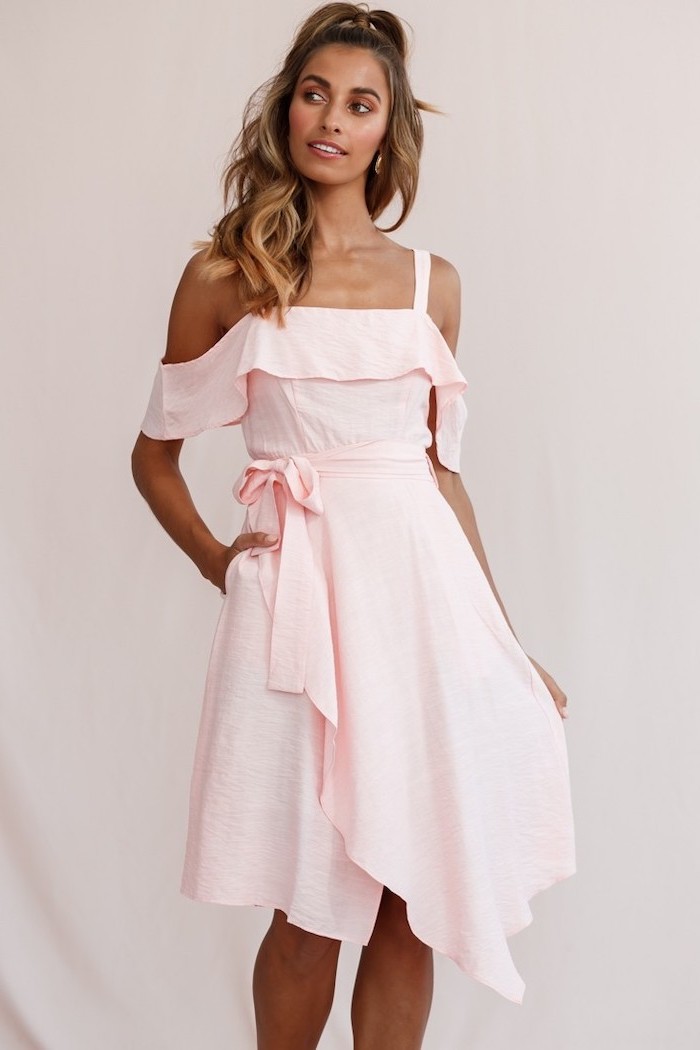 balayage hair on woman wearing light pink midi dress with bow on the waist summer beach dresses photographed on white background