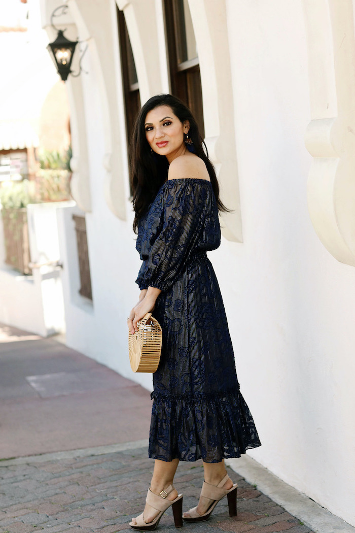 beach wedding guest dresses woman with long black hair wearing black strapless dress with navy blue decorations nude sandals