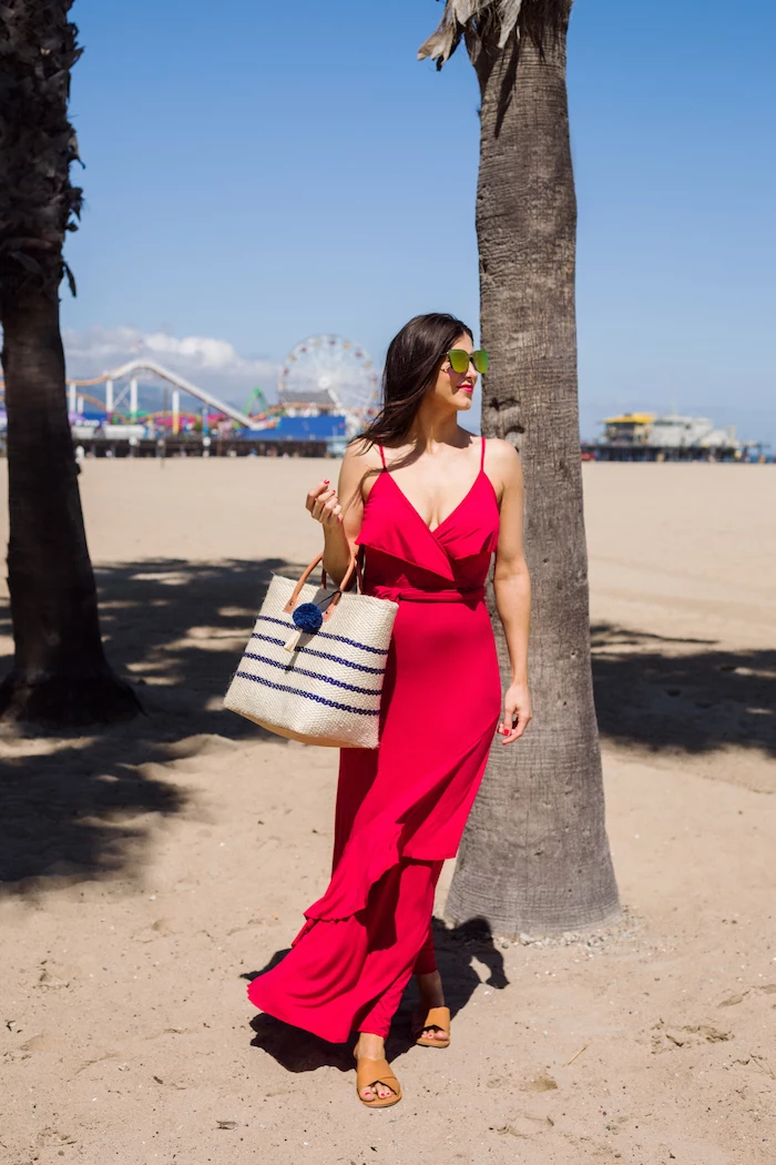 beach with park in the background white summer maxi dress woman on the beach wearing long red dress sunglasses
