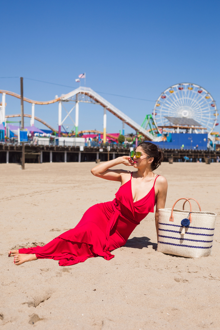 beach with park in the background white summer maxi dress woman on the beach wearing long red dress