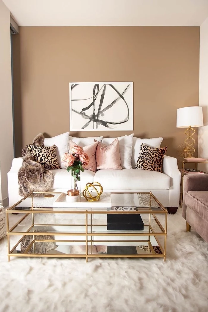 beige walls colors that go with grey white sofa with white and pink throw pillows with leopard print glass coffee table on white carpet