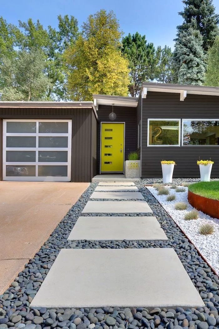black wooden house landscaping ideas for front of house tiled pathway in gravel leading to neon green door