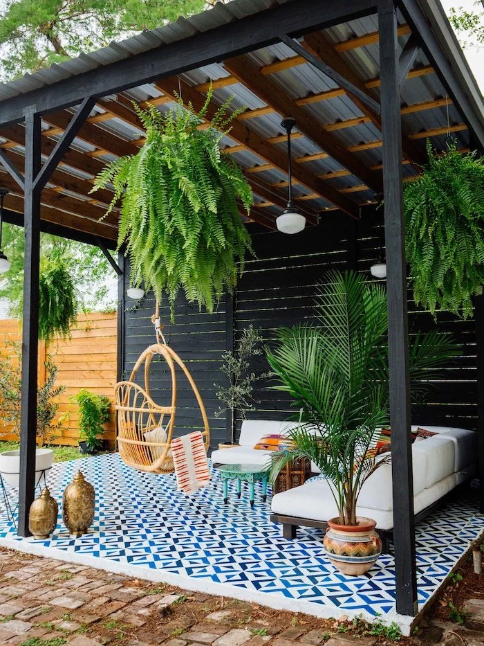 black wooden pergola backyard patio ideas wooden corner sofa with white cushions wooden swing lots of plants