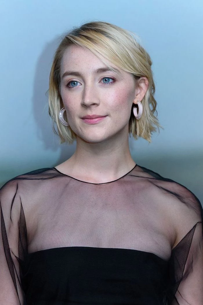 blonde wavy hair medium length hairstyles for thin hair saoirse ronan wearing black tulle dress standing in front of blue wall