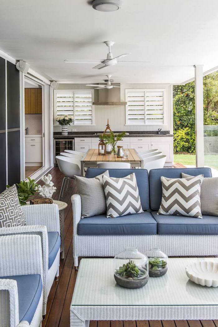 blue cushions on white garden furniture set on wooden floor stone patio ideas otdoor kitchen and dining area