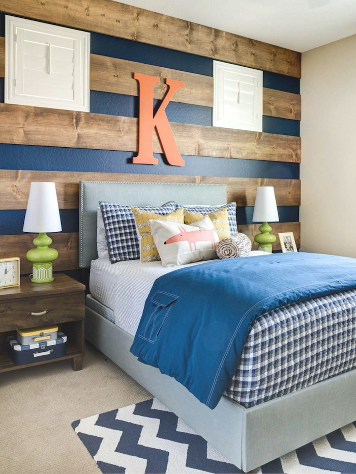 blue stripes wooden beams on the wall behind the bed bedroom ideas for teenage guys with small rooms orange letter k above the bed