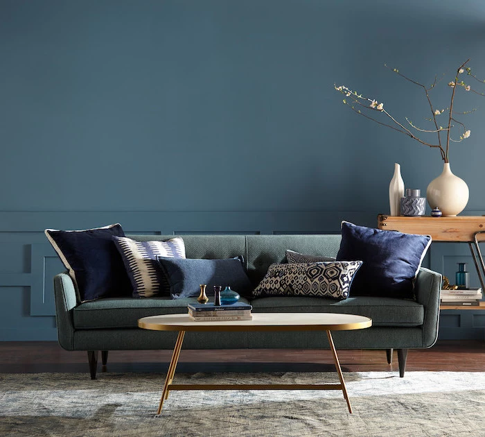 blue wall living room color schemes grey sofa with navy blue throw pullows wooden floor side table brass coffee table
