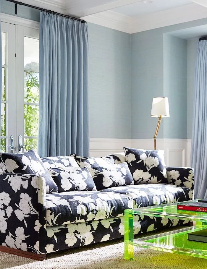 blue walls and curtains living room wall colors black sofa with white flowers print green glass coffee table