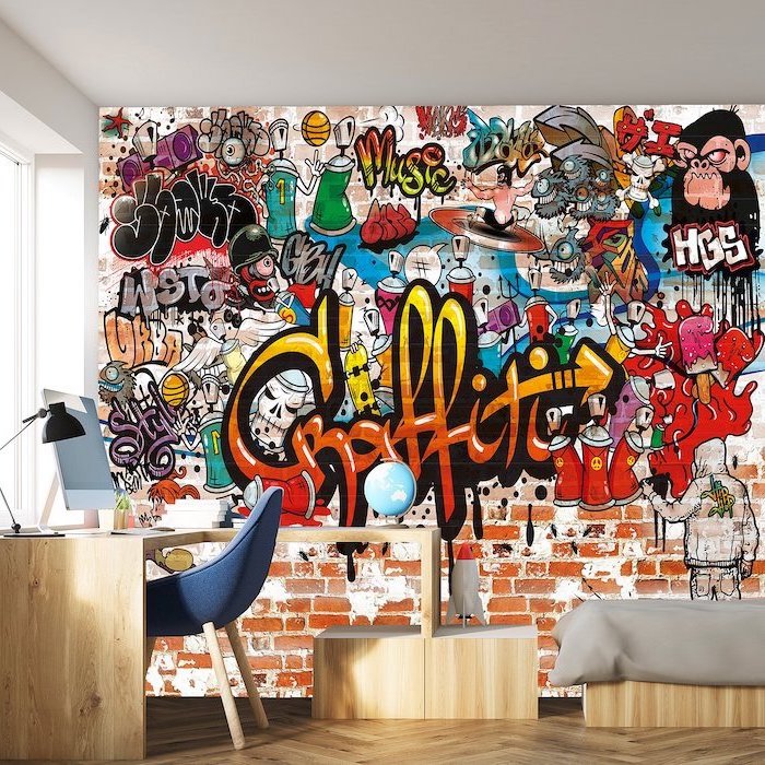 boys bedroom furniture wooden desk with blue chair wall filled with graffiti stickers behind them