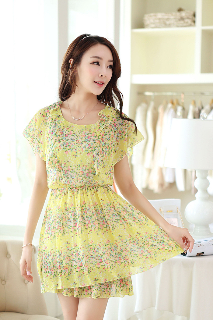 brunette woman wearing yellow dress with pink flowers casual summer dresses white diadem on her head