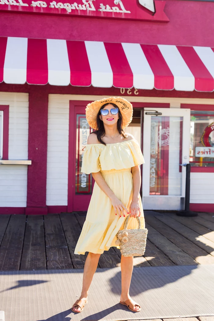 brunette woman wearing yellow strapless dress straw hat sunglasses brown leather sandals white summer maxi dress