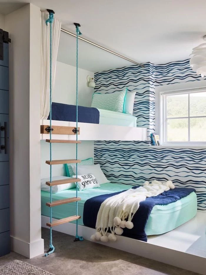 bunk beds with turquoise sheets pillows dark blue blankets ladder boys bedroom ideas blue waves on white walls