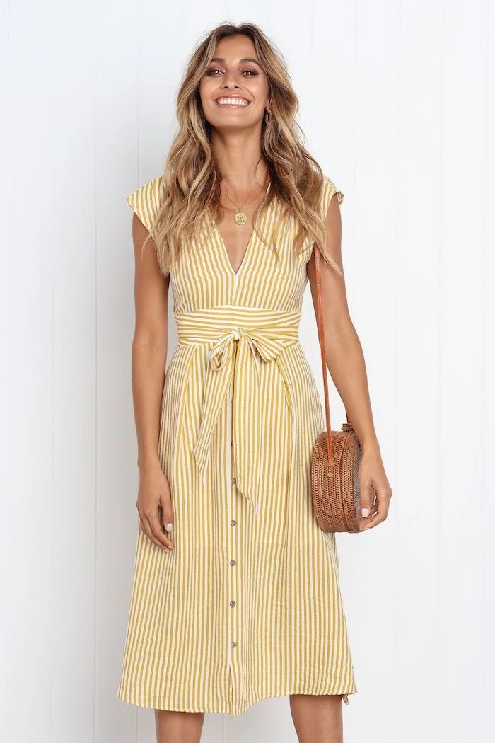 casual summer dresses woman with long blonde wavy hair wearing white dress with yellow stripes brown bag