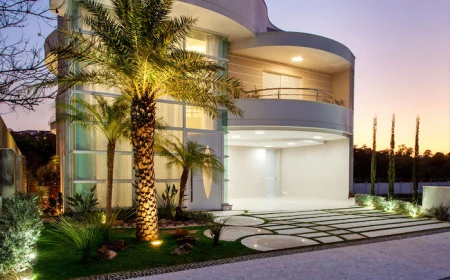cheap landscaping ideas two storey modern house with tiled pathway small lit garden at the front with palm trees bushes