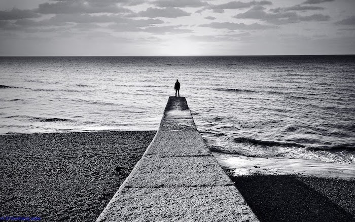 cool wallpaper hd black and white photo of man standing at the end of pier looking at the ocean