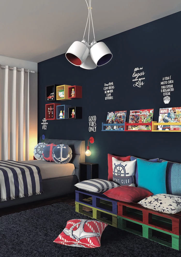 dark blue accent wall boys bedroom ideas maritime themed throw pillows small sofa made of pallets painted in blue red yellow green