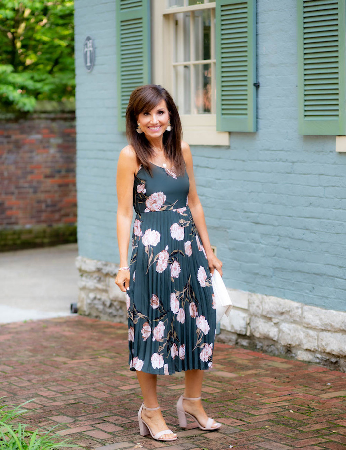 dark blue dress with pink flowers worn by woman with medium length brown hair elegant dresses for wedding guests light pink sandals