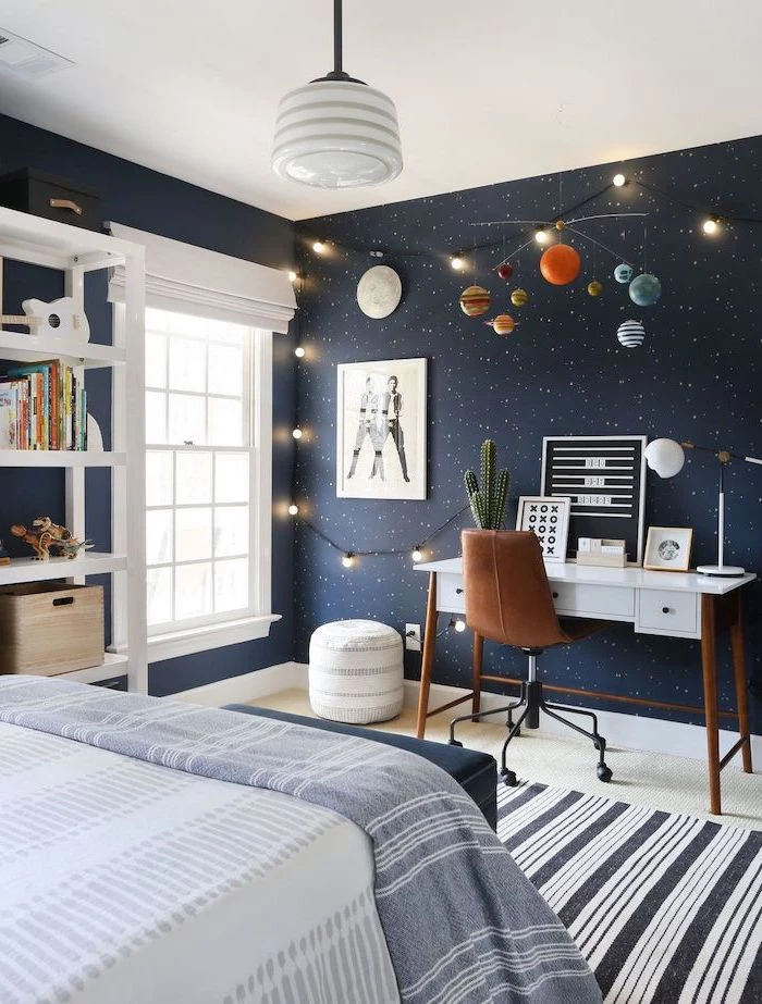 dark blue wall with stars led lights planets chandelier boys room paint ideas white wooden desk with brown leather chair