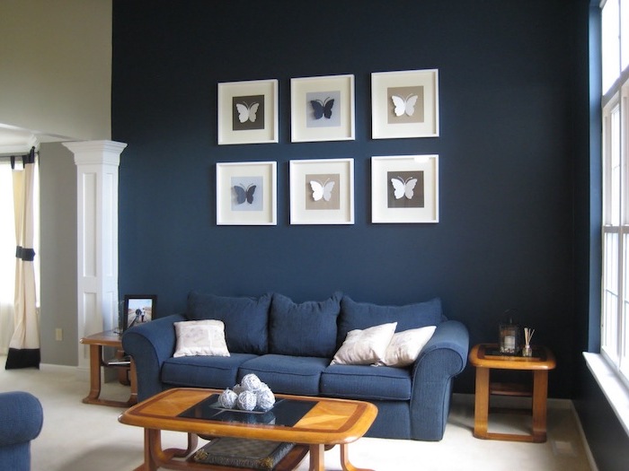 dark navy blue walls with paper butterflies wall art interior paint colors navy blue sofa wooden coffee table and side tables