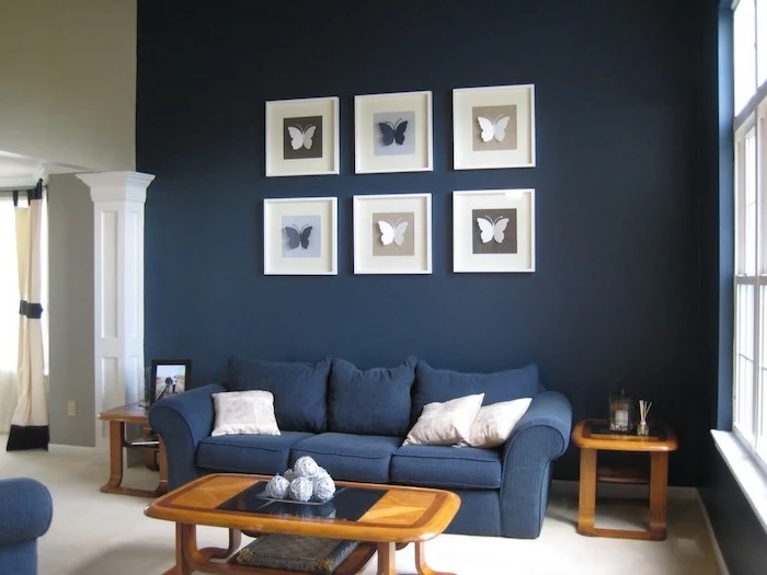dark navy blue walls with paper butterflies wall art interior paint colors navy blue sofa wooden coffee table and side tables