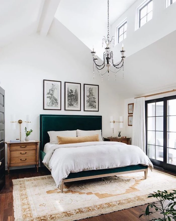 dark velvet green backboard on bed with white bed sheets master bedroom ideas cathedral ceiling wooden floor with carpet